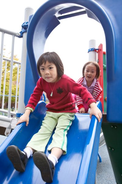 Child going down a playground slide.
